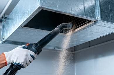 Dryer vent duct being professionally cleaned
